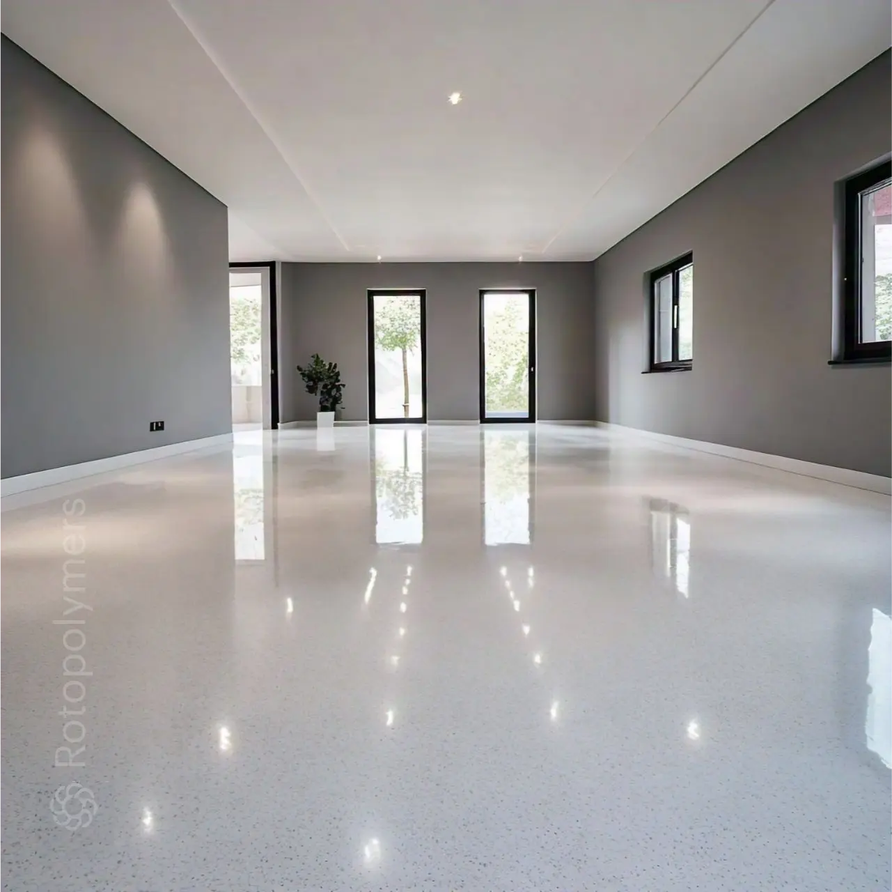 Seamless light grey epoxy floor in an empty showroom